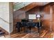 Elegant living area featuring a grand piano, hardwood floors, and rich wood paneling, creating a luxurious space at 3344 Peachtree Ne Rd # 3405, Atlanta, GA 30326