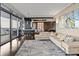 Stylish open-concept living room with modern furnishings, hardwood floors, balcony access, and an adjacent dining area at 3344 Peachtree Ne Rd # 3405, Atlanta, GA 30326