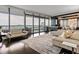 Bright living room featuring hardwood floors, a modern sofa, and floor-to-ceiling windows with a stunning city view at 3344 Peachtree Ne Rd # 3405, Atlanta, GA 30326