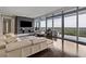 Contemporary living room boasting hardwood floors, a large TV, a comfortable sofa, and access to an outdoor balcony at 3344 Peachtree Ne Rd # 3405, Atlanta, GA 30326