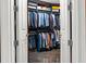 A walk-in closet with a wide variety of clothing on display and dark hardwood flooring at 3344 Peachtree Ne Rd # 3405, Atlanta, GA 30326