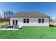 Exterior view of a well-maintained home with a charming back patio and lush green lawn at 440 Madison Lakeview Dr, Acworth, GA 30102