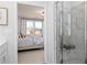 Bright bathroom featuring a glass enclosed shower and doorway view to bedroom at 440 Madison Lakeview Dr, Acworth, GA 30102