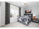 Cozy bedroom featuring a large window, patterned curtains, and a comfortable bed with stylish bedding at 440 Madison Lakeview Dr, Acworth, GA 30102