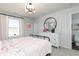 Well-lit bedroom with a metal bed frame, white dresser, and access to an ensuite bathroom at 440 Madison Lakeview Dr, Acworth, GA 30102