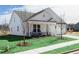 Beautiful home featuring a well-kept lawn, sidewalk, and a cozy front porch with rocking chairs at 440 Madison Lakeview Dr, Acworth, GA 30102