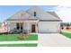 Charming single-Gathering home boasts a manicured lawn, two-car garage, and inviting covered porch at 440 Madison Lakeview Dr, Acworth, GA 30102