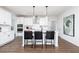 Eat-in kitchen with white cabinets, stainless appliances, and island with seating, perfect for entertaining at 440 Madison Lakeview Dr, Acworth, GA 30102