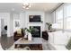 Bright living room featuring a fireplace, comfortable seating, and seamless entry to the laundry room at 440 Madison Lakeview Dr, Acworth, GA 30102