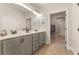 Bathroom featuring double sinks, gray cabinets, and an open entrance to the walk in closet at 48 Masters Dr, Villa Rica, GA 30180