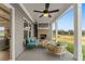 Covered patio with an outdoor fireplace, comfortable seating, and views of the green lawn at 48 Masters Dr, Villa Rica, GA 30180