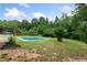 A lush green backyard with a swimming pool and mature trees and landscaping at 1645 Oakfield Ln, Roswell, GA 30075