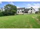 Large backyard with manicured lawn and a view of the home's rear exterior with a deck at 1645 Oakfield Ln, Roswell, GA 30075