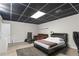 Comfortable finished basement has a bed, tv, sofa, and durable flooring, great for relaxing and hosting guests at 1645 Oakfield Ln, Roswell, GA 30075