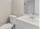 Bathroom with white vanity and a mirror reflecting toilet and tiled walk in shower at 1645 Oakfield Ln, Roswell, GA 30075