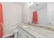 Bathroom featuring granite countertop, white vanity, and a mirror reflecting the shower at 1645 Oakfield Ln, Roswell, GA 30075