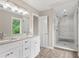 Bright bathroom with double vanity, granite countertops, a large mirror, and a walk-in glass shower at 1645 Oakfield Ln, Roswell, GA 30075