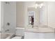 Bright bathroom featuring subway tile, white vanity with granite countertop, and modern fixtures at 1645 Oakfield Ln, Roswell, GA 30075