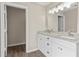 Bathroom featuring double sink vanity with granite countertops, white cabinets and a large mirror at 1645 Oakfield Ln, Roswell, GA 30075
