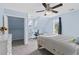 Bedroom with blue walls and carpet, ceiling fan, bed, closet, and two windows at 1645 Oakfield Ln, Roswell, GA 30075