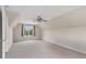 Large bedroom featuring neutral walls, carpet, a ceiling fan, and a window at 1645 Oakfield Ln, Roswell, GA 30075