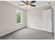 Bedroom with neutral walls, carpet, a window with a backyard view, and white trim at 1645 Oakfield Ln, Roswell, GA 30075
