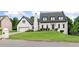 Charming home featuring a well-manicured lawn, black roof, white facade, and an attached garage at 1645 Oakfield Ln, Roswell, GA 30075