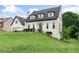Charming home featuring a well-manicured lawn, black roof, white facade, and an attached garage at 1645 Oakfield Ln, Roswell, GA 30075