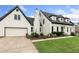 Charming home featuring a well-manicured lawn, black roof, white facade, and an attached garage at 1645 Oakfield Ln, Roswell, GA 30075