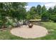 Outdoor fire pit area with gravel, chairs, and lush greenery, perfect for cozy evenings and gatherings at 1645 Oakfield Ln, Roswell, GA 30075