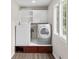 Well-organized laundry room with washer, dryer, built-in storage, and a bright window at 1645 Oakfield Ln, Roswell, GA 30075