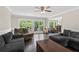 Open-concept living room leading to outdoor deck with comfortable seating area at 1645 Oakfield Ln, Roswell, GA 30075