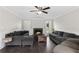 Spacious living room with fireplace, dark wood floors, and large sectional sofas at 1645 Oakfield Ln, Roswell, GA 30075