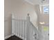 Bright staircase with white railings and carpet steps, leading to the upper level of the home at 1645 Oakfield Ln, Roswell, GA 30075