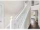 Bright staircase with white railings and carpet steps, leading to the upper level of the home at 1645 Oakfield Ln, Roswell, GA 30075