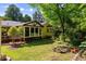 Landscaped backyard with a pond, deck, and sunroom at 1652 Oak Grove Rd, Decatur, GA 30033