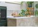 Close up of tiled bathtub with plants and bath accessories at 1652 Oak Grove Rd, Decatur, GA 30033