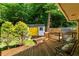 Backyard deck leading to a shed with bright yellow doors at 1652 Oak Grove Rd, Decatur, GA 30033