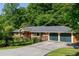 Well-maintained home with a two-car garage and a green front yard at 1652 Oak Grove Rd, Decatur, GA 30033