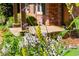Beautiful front yard landscaping with colorful flowers and a glimpse of the brick home's porch at 1652 Oak Grove Rd, Decatur, GA 30033