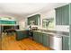 Kitchen with wood floors, granite countertops, stainless steel appliances, and green cabinets at 1652 Oak Grove Rd, Decatur, GA 30033