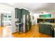 Open kitchen featuring wood flooring, a large island, and stainless steel refrigerator at 1652 Oak Grove Rd, Decatur, GA 30033