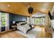 Large main bedroom features hardwood floors, black accent wall, wood ceiling, and sitting area at 1652 Oak Grove Rd, Decatur, GA 30033