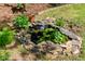 Rock-lined backyard pond with plants and foliage at 1652 Oak Grove Rd, Decatur, GA 30033