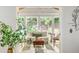 Bright sunroom with a cozy sitting area, lots of natural light, and views of surrounding greenery at 1652 Oak Grove Rd, Decatur, GA 30033