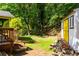 View of a lush backyard featuring a shed with bright yellow doors at 1652 Oak Grove Rd, Decatur, GA 30033