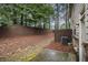 Backyard with a patio area, surrounded by trees, providing privacy and natural beauty at 2294 Spicy Pine Ln, Lawrenceville, GA 30044