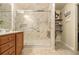 Bathroom featuring modern walk-in shower with marbled walls, grab bar, and shelving at 2294 Spicy Pine Ln, Lawrenceville, GA 30044