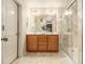 Well-lit bathroom featuring a double vanity and glass-enclosed marble shower at 2294 Spicy Pine Ln, Lawrenceville, GA 30044