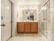 Bright bathroom featuring a double vanity, large mirror, and walk-in shower with glass doors at 2294 Spicy Pine Ln, Lawrenceville, GA 30044